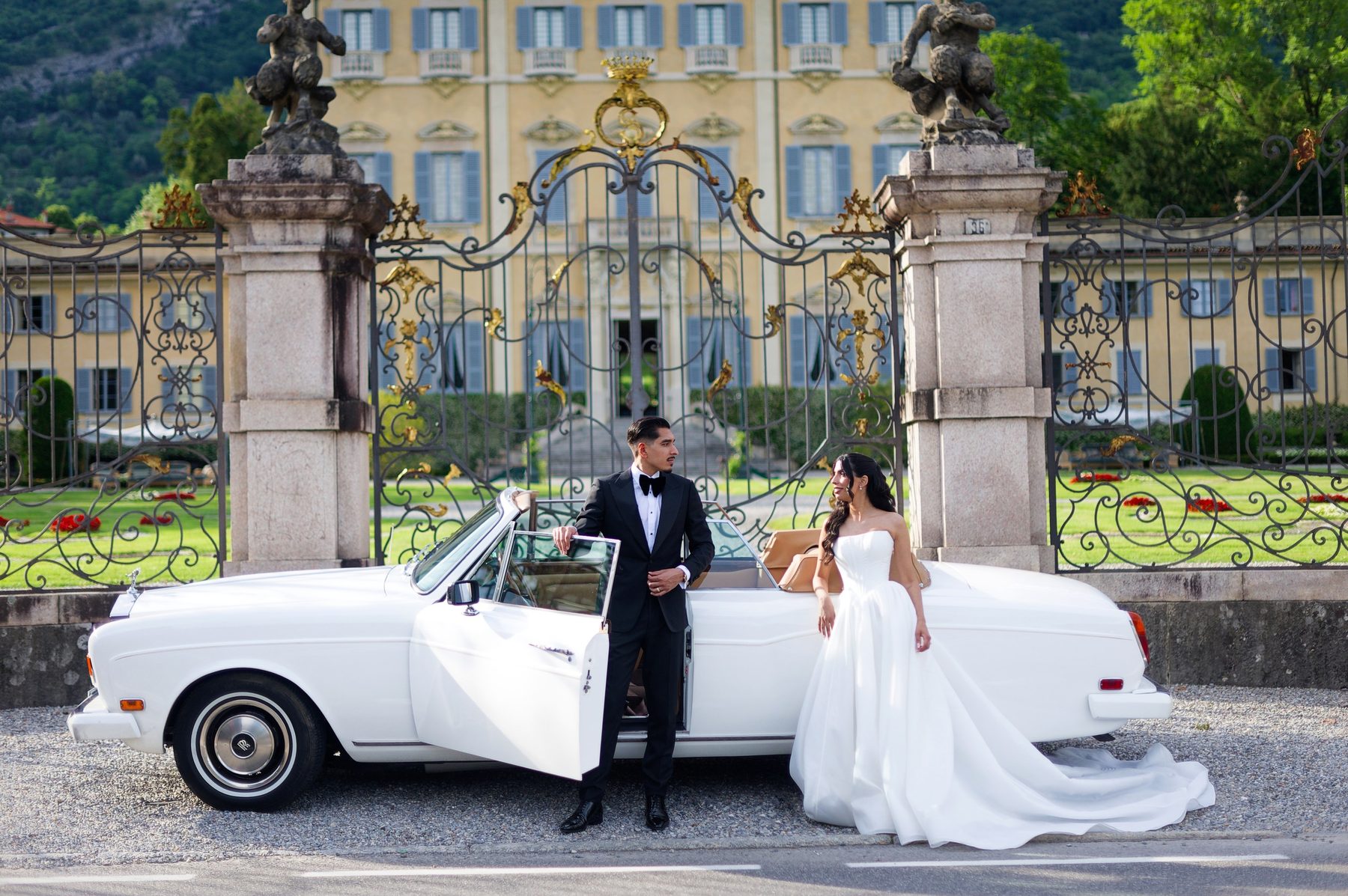 A white classic car waiting at the villa gates