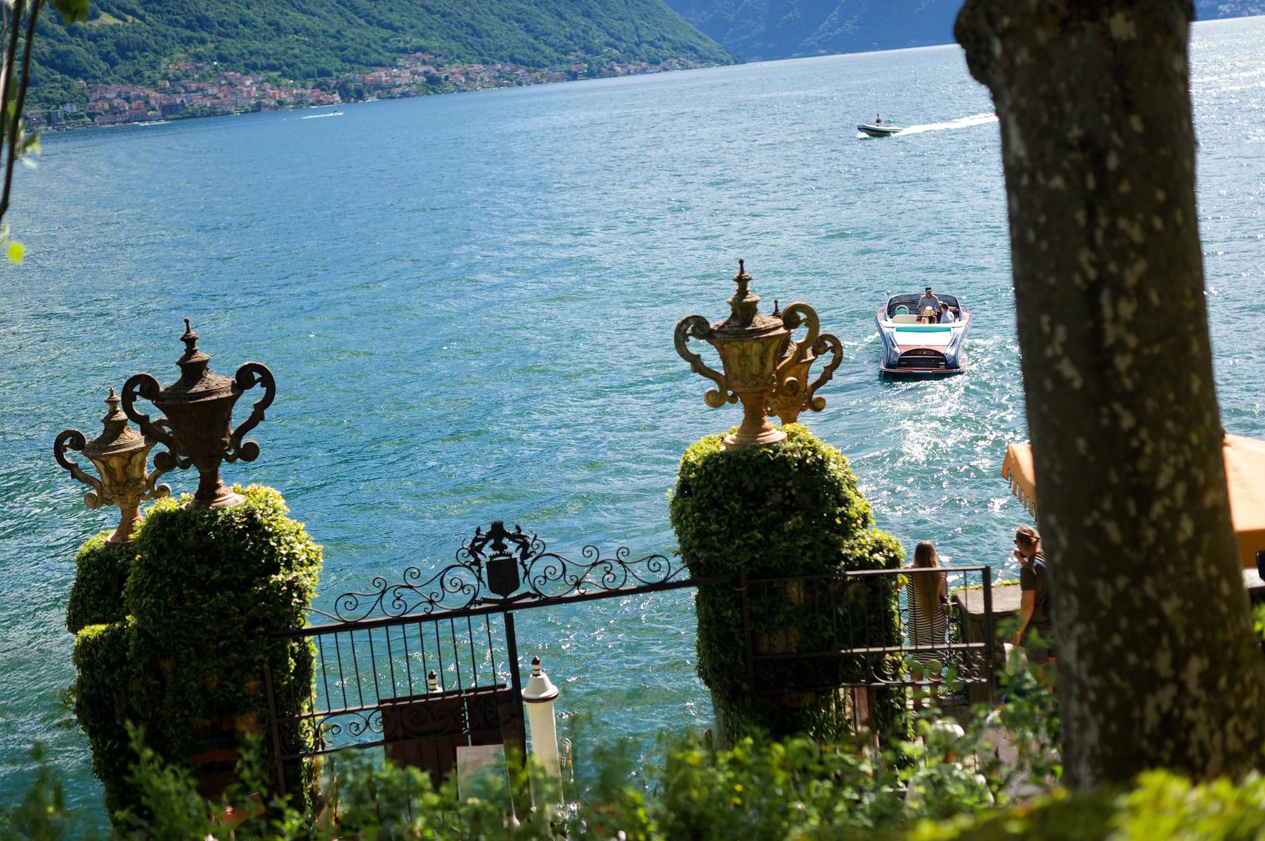 The lake seen past a gilded statue on the villa terrace